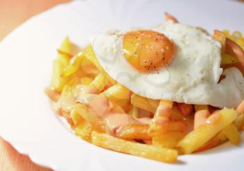 A Plate of French Fries with Fried Egg and Chilli Mayonnaise.