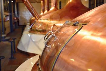 View of beer brewery interior with traditional fermenting copper vats.