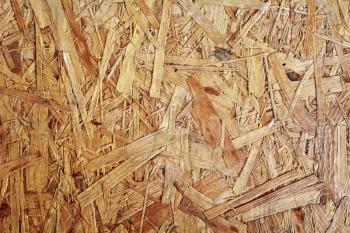 Full frame background shot of a brown chipboard.