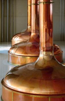 View of beer brewery interior with traditional fermenting copper vats.