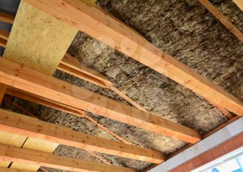Roof and attic insulation over wooden beams in a new house. 