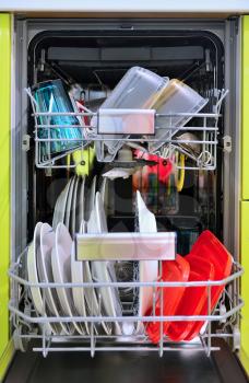 Front view of fully loaded dishwasher with washed clean dishes.
