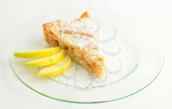 One serving of apple cake on white background.