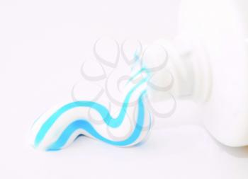 A toothpaste squeezed from a tube on white background.