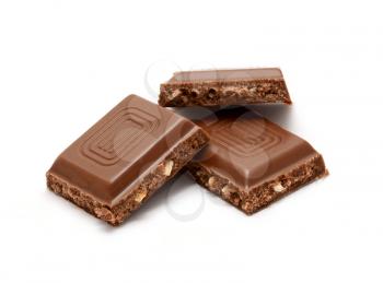 Three squares of milk nut chocolate bar over white background.