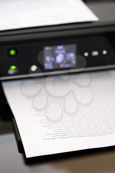Printed paper with lorem ipsum text in modern inkjet printer.