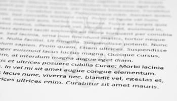Closeup of lorem ipsum text on white paper.