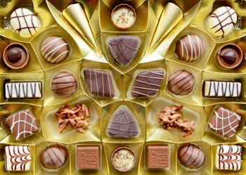 Selection of fine milk and dark chocolate belgian pralines, top view full frame background.