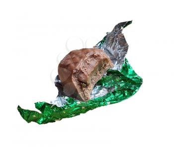 Chocolate truffle with a missing bite in unwrapped aluminum foil, isolated on white background.