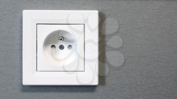 Closeup of classic European power, electric wall outlet switch, socket. White EU electric socket.