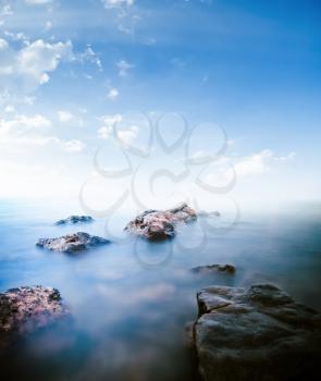 Stones calm sea. Long exposure shot outdoor landscape