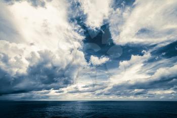 Dark clouds in open ocean. Tropical hurricane and sea storm