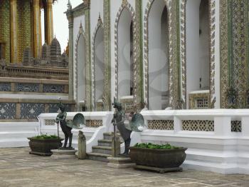 statues of roosters guards at the entrance to Temple of the Emerald Buddha