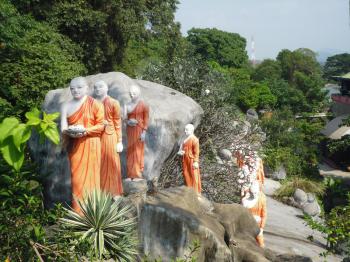 the statue of a string of monks near a temple in Dambulla Sri Lanka