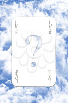 Joker Playing Card Over The Blue Cloudy Sky