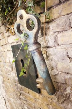 Vintage Giant Key And Keyhole On The Brick Wall
