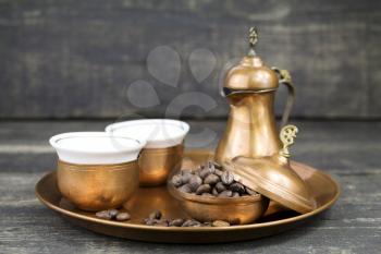 Turkish coffee with traditional copper serving set and coffee beans 