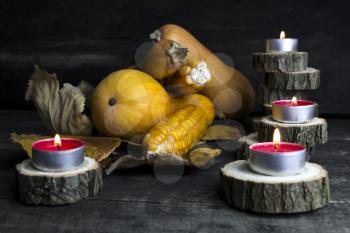 Happy Thanksgiving Day, Decoration on a wooden table with Pumpkins, Corncob, Burning Candles and autumn leaves