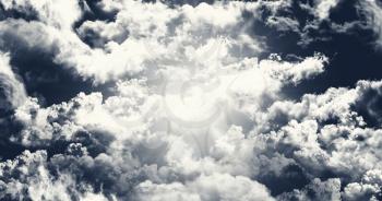 Dark Sky With White Fluffy Clouds Illustration