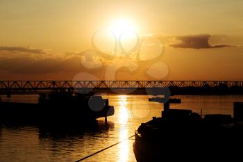 Beautiful Golden Sunset with Ships and Bridge Silhouettes At The River Danube in Belgrade Serbia