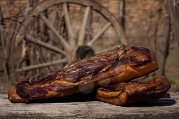 Whole Smoked Bacon Slab Resting On A Rustic Wooden Surface. Delicious Domestic Food