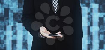 Businessman in Black Suit and Tie Holding Smartphone in Hand Against Futuristic Background