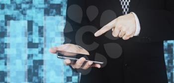 Businessman in Black Suit and Tie Holding Smartphone in Hand And Pointing Finger at Phones Screen Against White Background