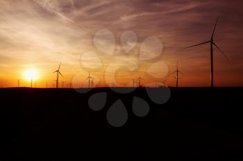 Wind Turbines Over Sunset Sky Generating Electricity. Sustainable Energy Power Generators, Renewable Power Supply