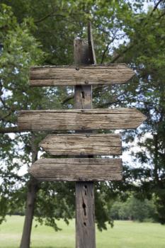 Wooden Arrows Direction Sign Post Against Nature Background