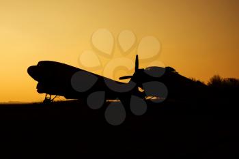 Silhouettes of Airplanes at the airport at Sunset
