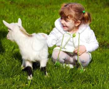 Beauty little girl and pet little goat