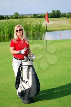 Beauty blonde girl playing golf