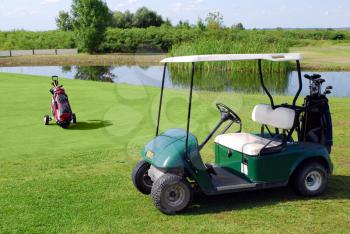 Golf buggy and golf bag on golf field