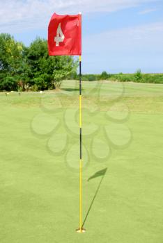 green golf field with red flag