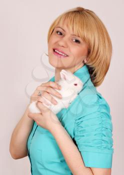 beautiful girl holding dwarf white rabbit
