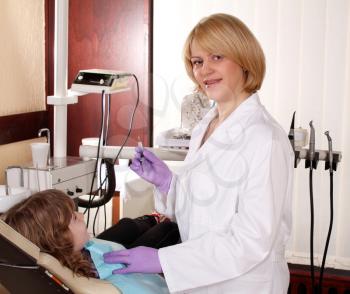 female dentist and child patient