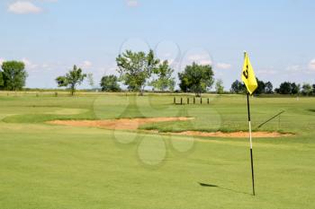 field with yellow golf flag