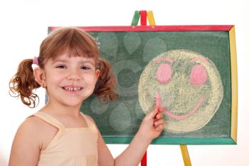 happy little girl drawing smiley face