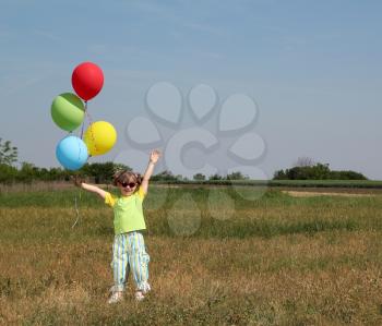 happy little girl with colorful balloons
