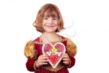 little girl holding gingerbread heart