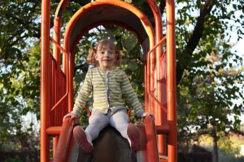 little girl on playground slide