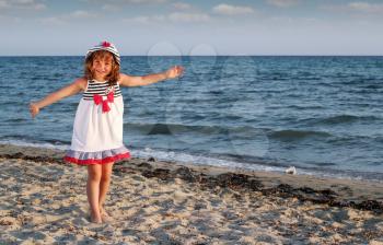 beautiful happy little girl on beach summer scene