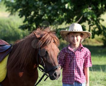 boy with cowboy hat and pony horse 