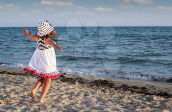 happy little girl running on beach