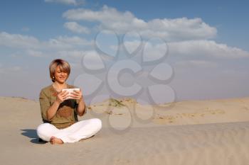 beautiful woman with tablet pc in desert