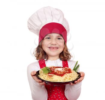 happy little girl cook holding dish with spaghetti