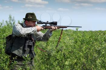 hunter aiming with sniper rifle