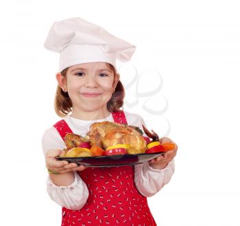 little girl cook holding roasted chicken