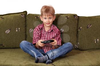 boy sitting on bed and play video game