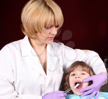 female dentist and little girl patient